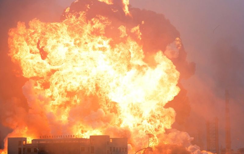 Smoke and fire engulfs a building after an explosion at a chemical plant in Rizhao, east China's Shandong province on July 16, 2015. State media reported the fire at the petrochemical plant which broke out after tanks containing liquefied hydrocarbon leaked at the plant has been brought under control and no casualties were reported.   CHINA OUT   AFP PHOTO / AFP / STR