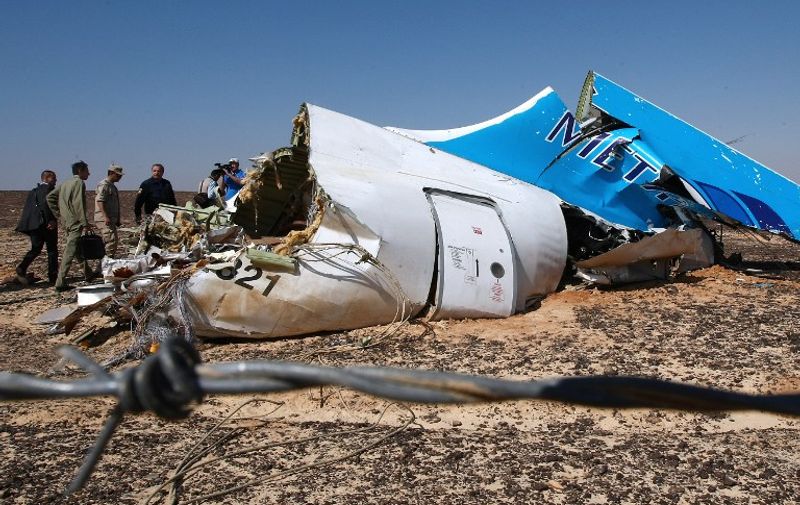 A handout picture taken on November 1, 2015 and released on November 3, 2015 by Russia's Emergency Ministry shows Russian Emergency Minister Vladimir Puchkov (4th L) visiting the crash site of a A321 Russian airliner in Wadi al-Zolomat, a mountainous area of Egypt's Sinai Peninsula. Russian airline Kogalymavia's flight 9268 crashed en route from Sharm el-Sheikh to Saint Petersburg on October 31, killing all 224 people on board, the vast majority of them Russian tourists. AFP PHOTO / RUSSIA'S EMERGENCY MINISTRY / MAXIM GRIGORYEV
*RESTRICTED TO EDITORIAL USE - MANDATORY CREDIT "AFP PHOTO / RUSSIA'S EMERGENCY MINISTRY / MAXIM GRIGORYEV" - NO MARKETING NO ADVERTISING CAMPAIGNS - DISTRIBUTED AS A SERVICE TO CLIENTS *