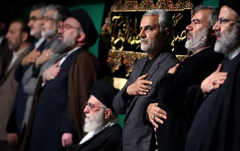 (FILES) This file handout photo released on March 27, 2015 by the official website of the Centre for Preserving and Publishing the Works of Iran's supreme leader Ayatollah Ali Khamenei, shows him (C) with the commander of the Iranian Revolutionary Guard's Quds Force, Gen. Qasem Soleimani (3rd from R), attending a religious ceremony in Tehran to commemorate the anniversary of the death of the daughter of Prophet Mohammed. - Top Iranian commander Qasem Soleimani was killed in a US strike on Baghdad's international airport on January 3, 2020, Iraq's powerful Hashed al-Shaabi paramilitary force has said, in a dramatic escalation of tensions between Washington and Tehran. (Photo by HO / KHAMENEI.IR / AFP)