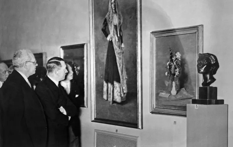 A picture taken in 1937 (no location specified), shows German nazi Chancellor  visiting an art exhibition in Germany.  The "House for German Art" was inaugurated in Munich on July 18, 1937 and the Munich "Degenerate Art" exhibition opened the day after, on July 19, 1937. AFP PHOTO (Photo by FRANCE PRESSE VOIR / AFP)
