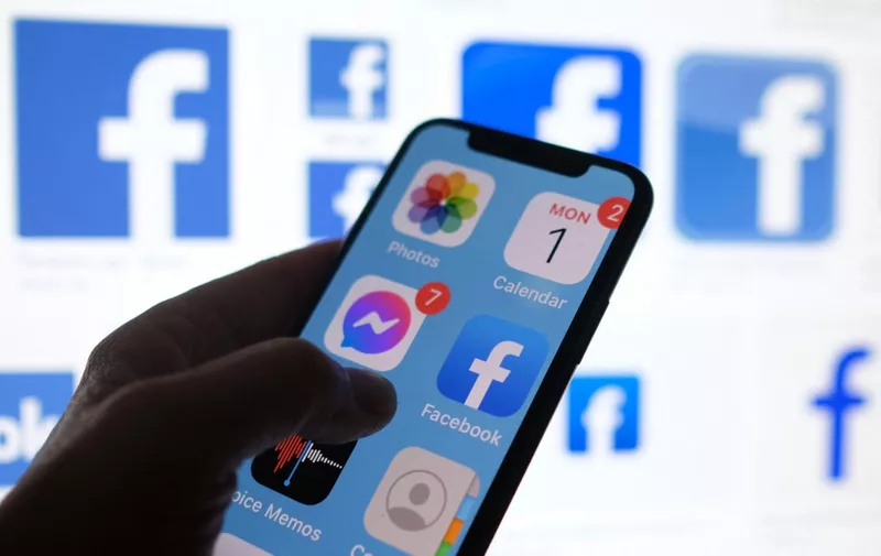 This illustration photo shows a Facebook App logo displayed on a smartphone in Los Angeles, March 1, 2021. (Photo by Chris DELMAS / AFP)