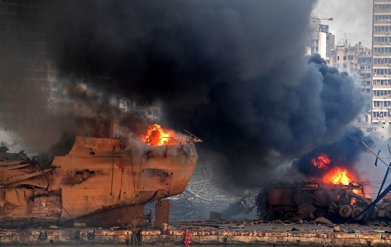 Flames engulf ships and vehicles at the port of Beirut following a massive explosion that hit the heart of the Lebanese capital on August 4, 2020. - Rescuers searched for survivors in Beirut on August 5 after a cataclysmic explosion at the port sowed devastation across entire neighbourhoods, killing more than 100 people, wounding thousands and plunging Lebanon deeper into crisis. (Photo by - / AFP)