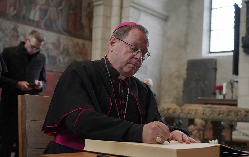 The Limburg Bishop Georg Batzing signs the book of condolence for the retired Pope Benedict in the Limburg Cathedral. Pope Emeritus Benedict XVI. died in the Vatican on December 31, 2022 at the age of 95. (Photo by Hasan Bratic / Hasan Bratic / dpa Picture-Alliance via AFP)