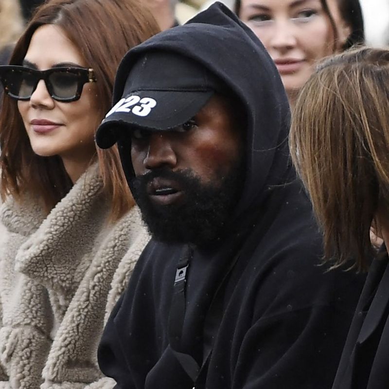 US rapper Kanye West (C), attends the Givenchy Spring-Summer 2023 fashion show during the Paris Womenswear Fashion Week, in Paris, on October 2, 2022. (Photo by JULIEN DE ROSA / AFP)