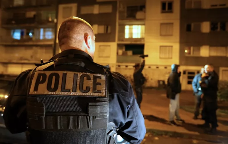 Police officers enforce a curfew at a housing project of the Champs Plaisants district of Sens, southeast of Paris, on November 20, 2015, where for the first time since the announcement of a state of emergency, a curfew was declared today for the duration of the weekend, following the discovery of weapons and false documents during administrative searches conducted by police earlier in the day. Gunmen and suicide bombers went on a killing spree in Paris on November 13, attacking the concert hall Bataclan as well as bars, restaurants and the Stade de France. Islamic State jihadists operating out of Iraq and Syria released a statement claiming responsibility for the coordinated attacks that killed 130 and injured over 350. AFP PHOTO / FRANCOIS NASCIMBENI / AFP / FRANCOIS NASCIMBENI