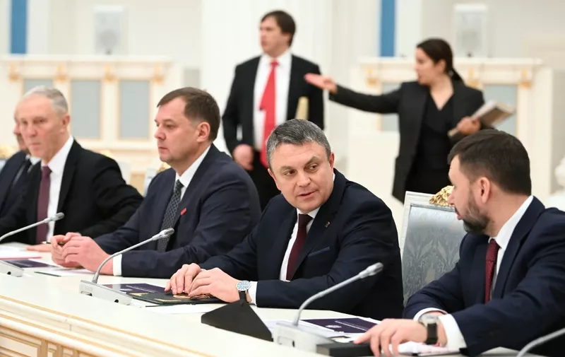 In this pool photograph distributed by Russian state agency Sputnik, the Moscow-appointed heads of the Kherson and Zaporizhzhia regions of Ukraine - which are controlled by Russian forces, Vladimir Saldo (L) and Yevgeny Balitsky (2L), Donetsk separatist leader Denis Pushilin (R) and Lugansk separatist leader Leonid Pasechnik (2R) attend a meeting on the social-economic development of the Russian-controlled regions of Ukraine chaired by Russian President, at the Kremlin in Moscow on January 31, 2024. (Photo by Kristina Kormilitsyna / POOL / AFP)