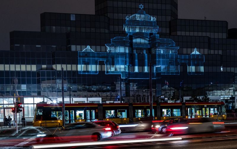 A photo shows a projection of the Great Synagogue of Warsaw, which was destroyed by the German forces during World War II, onto a glass skyscraper, during ceremonies to mark the 80th anniversary of the start of the Warsaw Jewish Ghetto Uprising, in downtown Warsaw, Poland, on April 19, 2023. (Photo by Wojtek RADWANSKI / AFP)