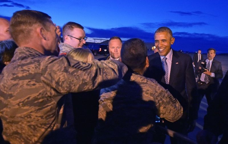 US President Barack Obama greets base personnel and well-wishers upon arrival at Hill Air Force Base on April 2, 2015 in Utah. AFP PHOTO/MANDEL NGAN