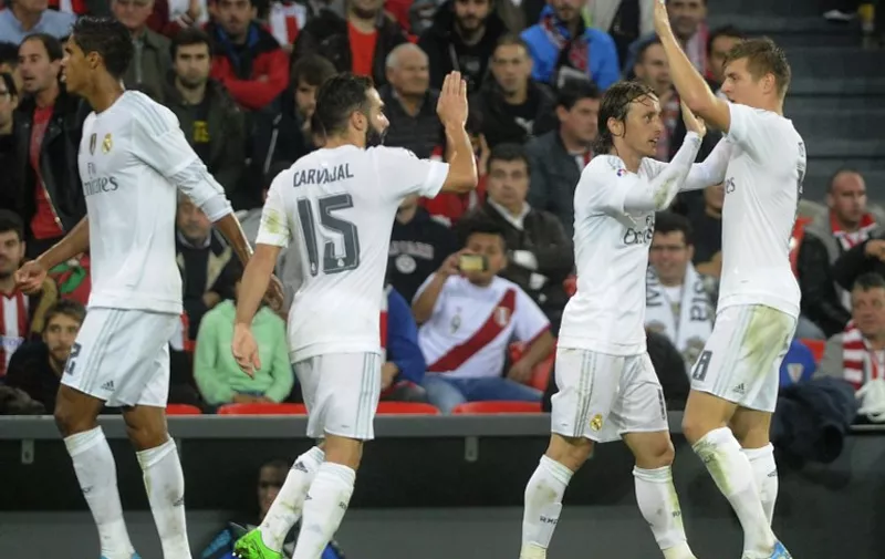 (From L to R) Real Madrid's French defender Raphael Varane, defender Daniel Carvajal, Croatian midfielder Luka Modric and German midfielder Toni Kroos celebrate after scoring during the Spanish league football match Athletic Club vs Real Madrid CF at the San Mames stadium in Bilbao on September 23, 2015. 