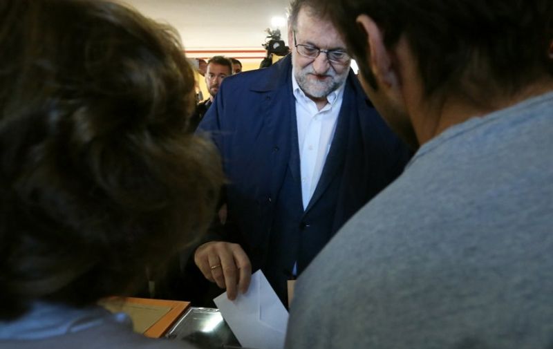 Spanish Prime Minister and Popular Party (PP) leader and candidate for general election, Mariano Rajoy casts his vote at a polling station in Madrid on December 20, 2015. Spaniards go to the polls today in what is expected to be one of the most closely-fought contests in modern history, as two dynamic new parties take on the country's long-established giants.  AFP PHOTO / CESAR MANSO / AFP / CESAR MANSO