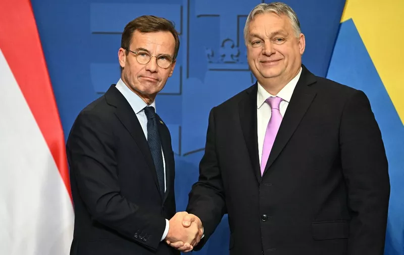 Swedish Prime Minister Ulf Kristersson (L) and his Hungarian counterpart and host Viktor Orban shake hands after a joint press conference in the Prime Minister's office of Carmelita monastery in Budapest, Hungary, on February 23, 2024. Swedish Prime Minister Ulf Kristersson meets Hungarian counterpart Viktor Orban on February 23, three days ahead of a key parliamentary vote on Sweden's bid to join NATO. Following Turkey's ratification last month, Hungary remains the last NATO member stopping Sweden from joining the alliance. (Photo by ATTILA KISBENEDEK / AFP)