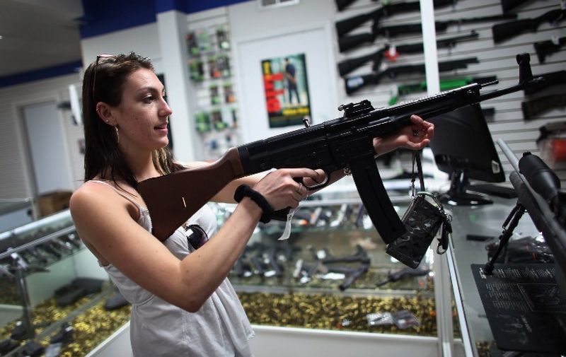 POMPANO BEACH, FL - APRIL 11: As the U.S. Senate takes up gun legislation in Washington, DC , Cristiana Verro looks at guns on sale at the National Armory gun store on April 11, 2013 in Pompano Beach, Florida. The Senate voted 68-31 to begin debate on a bill that would significantly expand background checks for gun sales.   Joe Raedle/Getty Images/AFP
