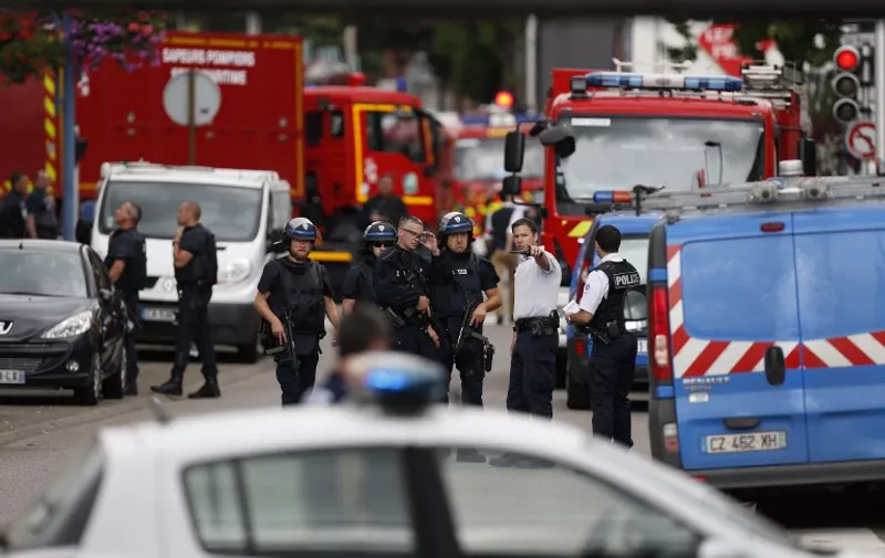 French police officers and fire engine arrive at the scene of a hostage-taking at a church in Saint-Etienne-du-Rouvray, northern France, on July 26, 2016 that left the priest dead.
A priest was killed on July 26 when men armed with knives seized hostages at a church near the northern French city of Rouen, a police source said. Police said they killed two hostage-takers in the attack in the Normandy town of Saint-Etienne-du-Rouvray, 125 kilometres (77 miles) north of Paris.

 / AFP PHOTO / CHARLY TRIBALLEAU
