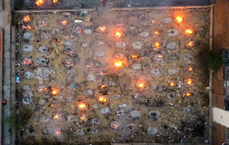 In this aerial picture taken on April 26, 2021, burning pyres of victims who lost their lives due to the Covid-19 coronavirus are seen at a cremation ground in New Delhi. (Photo by Jewel SAMAD / AFP)
