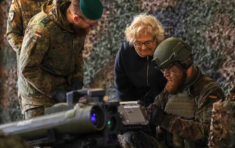 German Defence Minister Christine Lambrecht listens to explanations about the anti tank system MELLS that is used with the armoured "Marder" vehicle during her visit at the military base of an armored infantryman batallion in Marienberg, eastern Germany, on January 12, 2023. - Germany will supply Ukraine with about 40 Marder infantry fighting vehicles within weeks as part of a new phase of support coordinated with the US. (Photo by Odd ANDERSEN / AFP)