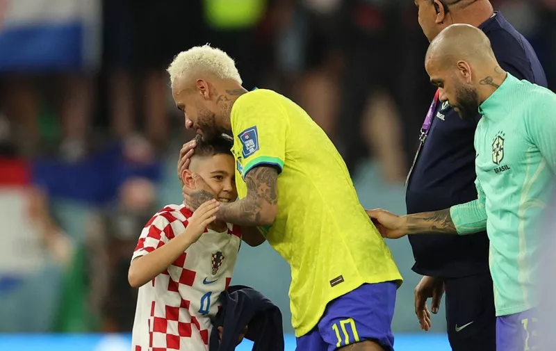 Brazil's forward #10 Neymar (C) is greeted by a Croatia supporter after his team lost the Qatar 2022 World Cup quarter-final football match between Croatia and Brazil at Education City Stadium in Al-Rayyan, west of Doha, on December 9, 2022. (Photo by Adrian DENNIS / AFP)