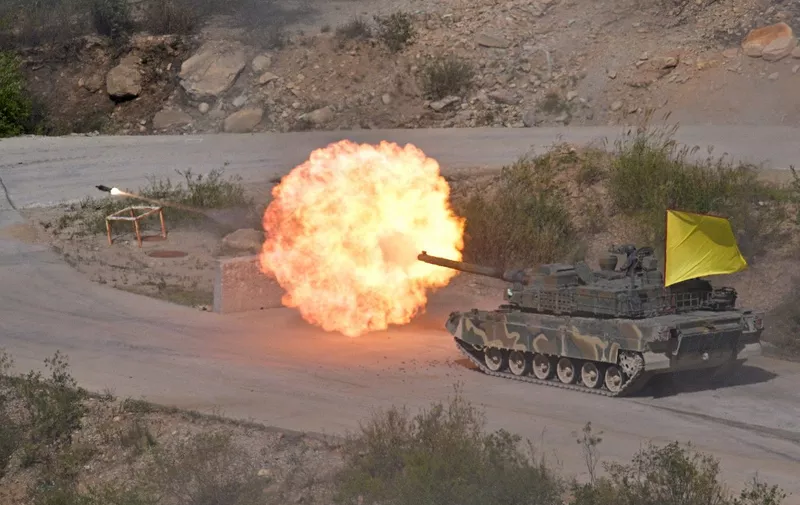 A South Korean Army K2 tank fires during a live fire military exercise during the Defense Expo Korea (DX Korea) at a training field near the demilitarized zone separating the two Koreas in Pocheon on September 20, 2022. (Photo by Anthony WALLACE / AFP)