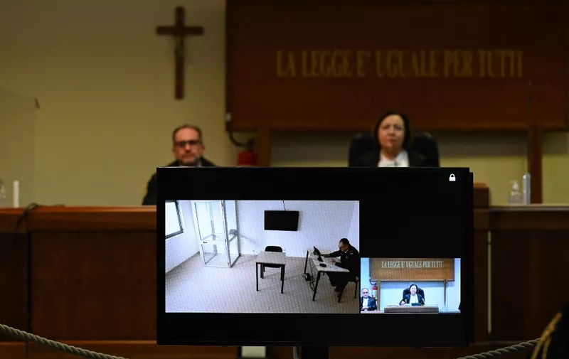 A television screen in a special bunker court in Caltanissetta, Sicily, on January 19, 2023, shows an empty chair where mafia boss Matteo Messina Denaro was expected to appear via videolink from his prison, for the 1992 Via D'Amelio bombing in Palermo, and the 1992 Capaci bombing. - Messina Denaro, 60, a convicted killer, was caught during a visit to the clinic on January 16, 2023 after 30 years on the run, after being forced to seek treatment for cancer. The 1992 Palermo bombing killed anti-mafia Italian magistrate Paolo Borsellino, as the Capaci bombing killed Italian magistrate Giovanni Falcone, his wife Francesca Morvillo, and three police escort agents. (Photo by Miguel MEDINA / AFP)