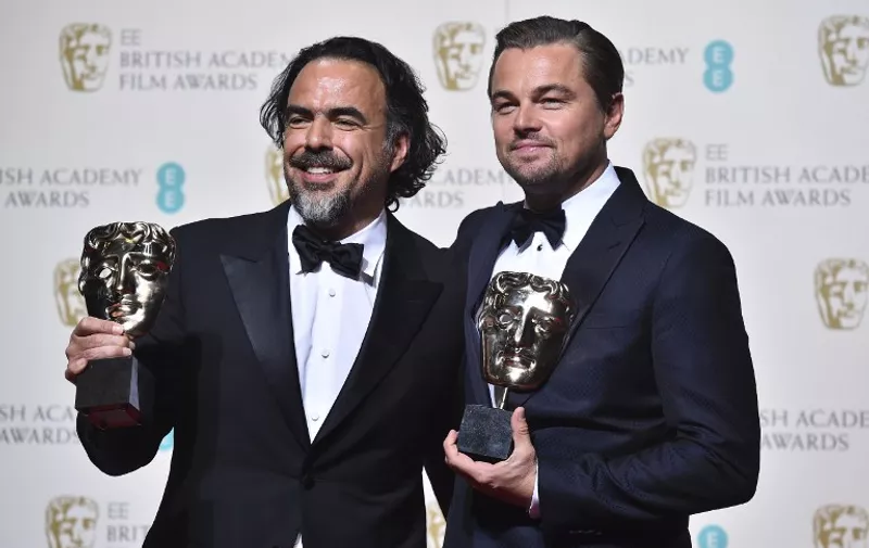 US actor Leonardo DiCaprio (R) poses with the award for a leading actor and Mexican director Alejandro Gonzalez Inarritu (L) with his award for a director both for the film 'The Revenant'  which won the award for best film at the BAFTA British Academy Film Awards at the Royal Opera House in London on February 14, 2016. AFP / BEN STANSALL / AFP / BEN STANSALL