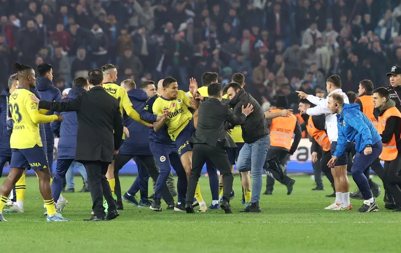 Soccer Football - Super Lig - Trabzonspor v Fenerbahce - Papara Park, Trabzon, Turkey - March 17, 2024 Trabzonspor fans invade the pitch and clash with Fenerbahce players and security staff after the match. REUTERS/Depo Photos  TURKEY OUT. NO COMMERCIAL OR EDITORIAL SALES IN TURKEY.