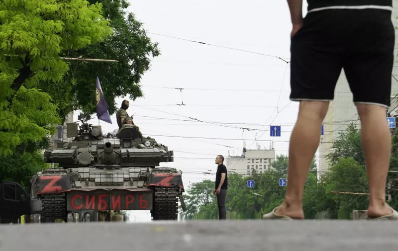 Members of Wagner group sit atop of a tank in a street in the city of Rostov-on-Don, on June 24, 2023. President Vladimir Putin on June 24, 2023 said an armed mutiny by Wagner mercenaries was a "stab in the back" and that the group's chief Yevgeny Prigozhin had betrayed Russia, as he vowed to punish the dissidents. Prigozhin said his fighters control key military sites in the southern city of Rostov-on-Don. (Photo by STRINGER / AFP)