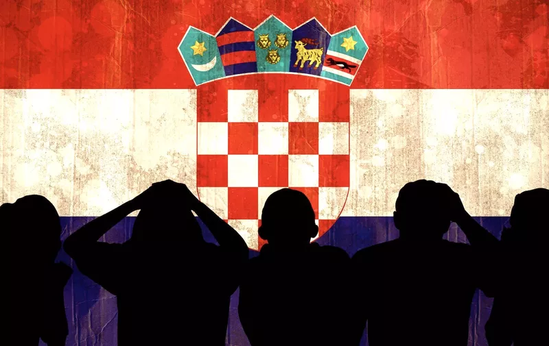 Silhouettes of football supporters against croatia flag in grunge effect