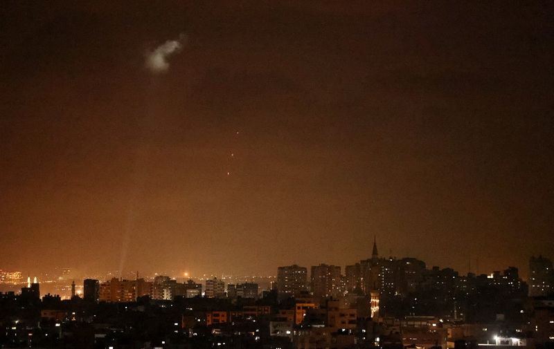 Shootings from the Palestinian territory light-up the night sky in Gaza city, on July 3, 2021, in response to the bombing of Israeli planes on Gaza military targets. - Israel attacked Gaza military targets late July 3, 2021, the army and Palestinian sources said, after incendiary balloons from the Palestinian territory caused fires in Israel in recent days. (Photo by MOHAMMED ABED / AFP)