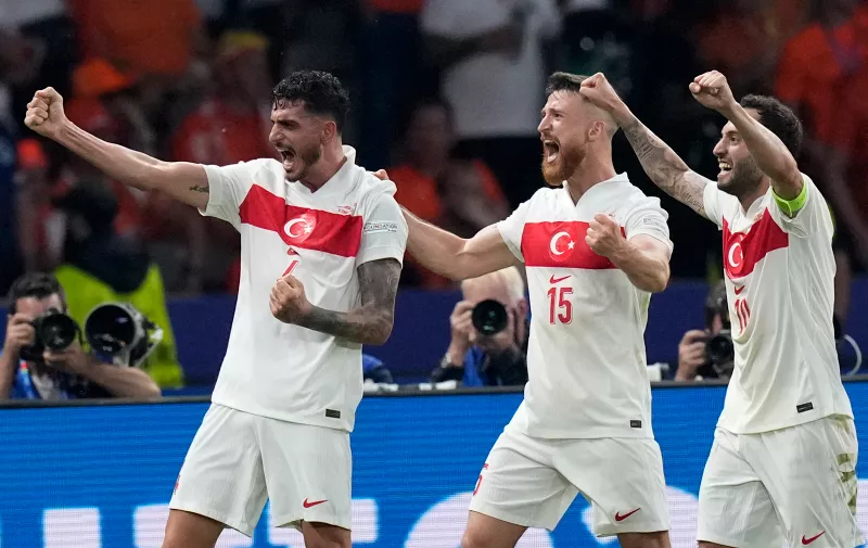 Turkey's Samet Akaydin, left, celebrates with teammates after scoring his sides first goal during a quarterfinal match between the Netherlands and Turkey at the Euro 2024 soccer tournament in Berlin, Germany, Saturday, July 6, 2024. (AP Photo/Ariel Schalit)