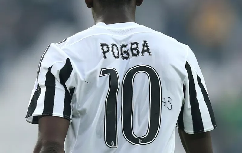 Juventus' midfielder Paul Pogba from France wears the jersey number 10 with "75" hand written on the side during the Italian Serie A football match Juventus Vs Atalanta on October 25, 2015 at the "Juventus Stadium" in Turin.  AFP PHOTO / MARCO BERTORELLO
