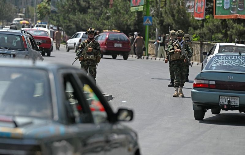 Taliban Fateh fighters, a "special forces" unit, patrol along a street in Kabul on August 29, 2021, as suicide bomb threats hung over the final phase of the US military's airlift operation from Kabul, with President Joe Biden warning another attack was highly likely before the evacuations end. (Photo by Aamir QURESHI / AFP)