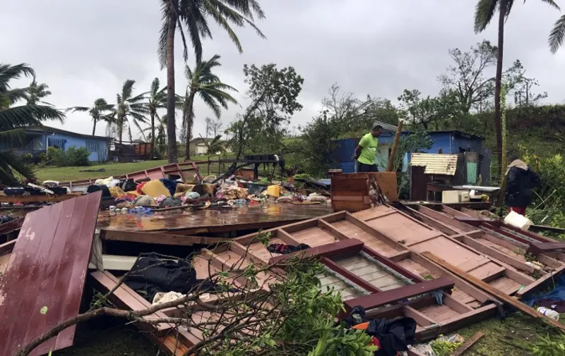 This handout photo taken by Naziah Ali of MaiLife Magazine on February 21, 2016 shows a family digging through the remains of their home in the town of Ba, after it was destroyed by severe tropical cyclone Winston, the only category five storm system to ever hit Fiji. Fiji began a massive clean-up on February 21 after the most powerful cyclone in its history battered the Pacific island nation, killing at least one person and leaving a trail of destruction.  AFP PHOTO / NAZIAH ALI / MAILIFE MAGAZINE 
 ----EDITORS NOTE ----RESTRICTED TO EDITORIAL USE MANDATORY CREDIT " AFP PHOTO / NAZIAH ALI / MAILIFE MAGAZINE " NO MARKETING NO ADVERTISING CAMPAIGNS - DISTRIBUTED AS A SERVICE TO CLIENTS - NO ARCHIVES / AFP / MAILIFE MAGAZINE / NAZIAH ALI