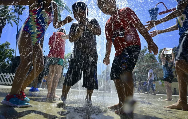 (FILES) In this file photo taken on July 27, 2019, children cool off at a water park in Alhambra, California as southern California endures another summer heatwave with triple-digit temperatures. - July 2019 temperatures were the hottest ever recorded globally, the US National Oceanic and Atmospheric Administration (NOAA) said Thursday, confirming earlier observations by the European Union. (Photo by Frederic J. BROWN / AFP)