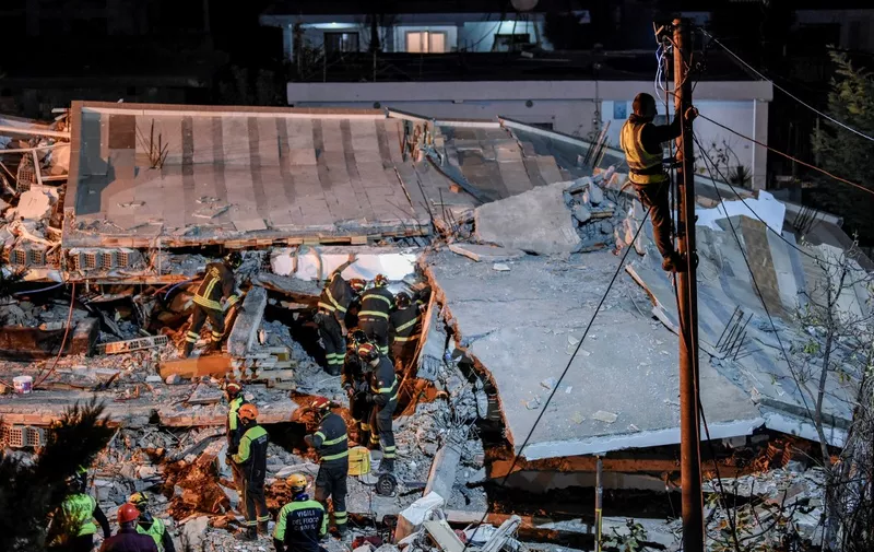 Italian search and rescue team search for six members of Lala family stuck under the rubble of a collapsed building in the town of Durres on November 27, 2019 in Durres, after an earthquake hit Albania. - Albania was in national mourning on November 27 as emergency workers continued to pull bodies from the ruins of buildings gutted by a violent earthquake, with nearly 30 dead found so far and more than 40 rescued alive. Tirana declared a state of emergency in the areas hardest-hit by the November 26 pre-dawn earthquake: the coastal city of Durres and the town of Thumane, where victims were trapped by toppled buildings. (Photo by Armend NIMANI / AFP)