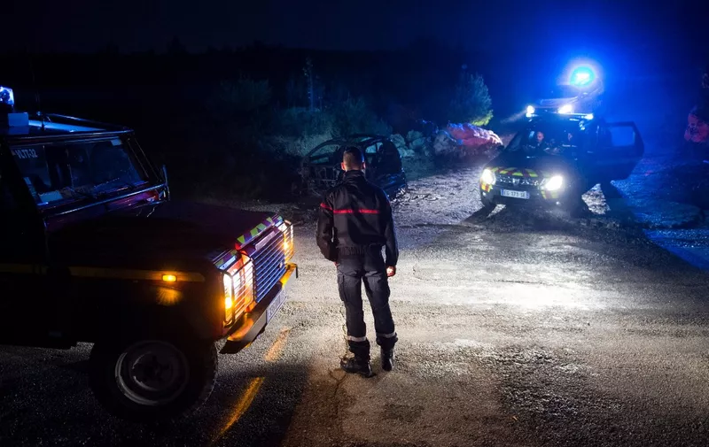 Police secure the area around the site near where a helicopter from the civil security services crashed while on a rescue mission for flood victims, in the hills in Le Rove, near Les-Pennes-Mirabeau outside the city of Marseille early on December 2, 2019. - Three emergency workers were killed in the helicopter crash near Marseille while on a rescue mission in southern France where floods have left two dead, officials said on December 2. (Photo by CLEMENT MAHOUDEAU / AFP)