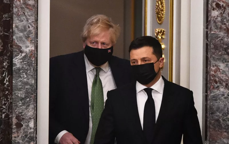 Ukrainian President Volodymyr Zelensky (R) and his British Prime Minister Boris Johnson arrive to hold a joint press conference following their talks in Kyiv on February 1, 2022, as Johnson visits in a show of support amid growing fears in the West of a Russian attack on Ukraine. - The British prime minister warned that Russian forces massed on the border represented a "clear and present danger" to Ukraine. Russian President accused the West of ignoring Moscow's security concerns and of using Ukraine as a tool to contain Russia though he said he hoped a solution could be found to end spiralling tensions. (Photo by Sergei SUPINSKY / AFP)
