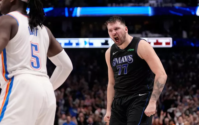 Dallas Mavericks' Luka Doncic (77) celebrates sinking a basket in front of Oklahoma City Thunder's Luguentz Dort (5) in the second half of Game 6 of an NBA basketball second-round playoff series Saturday, May 18, 2024, in Dallas. (AP Photo/Tony Gutierrez)