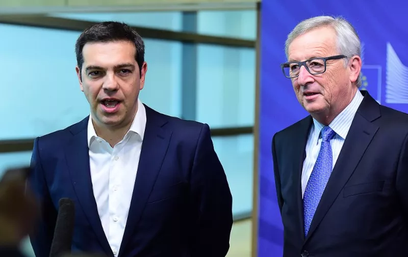 Greece's Prime Minister Alexis Tsipras (L) speaks to the press as he is welcomed by European Commission President Jean-Claude Juncker ahead of an emergency summit with the leaders of Athens' creditors at the European Commission in Brussels, on June 22, 2015. The European Central Bank (ECB) again increased emergency liquidity funds for Greece's banks on June 22, according to a Greek bank source who said the ECB may renew the hike "at any time" if necessary. AFP PHOTO / EMMANUEL DUNAND