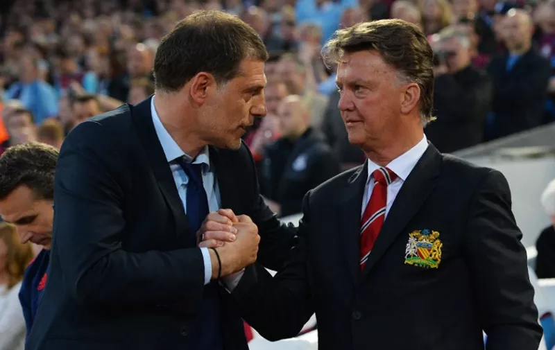 West Ham United's Croatian manager Slaven Bilic (L) greets Manchester United's Dutch manager Louis van Gaal before the English Premier League football match between West Ham United and Manchester United at The Boleyn Ground in Upton Park, in east London on May 10, 2016. / AFP PHOTO / GLYN KIRK / RESTRICTED TO EDITORIAL USE. No use with unauthorized audio, video, data, fixture lists, club/league logos or 'live' services. Online in-match use limited to 75 images, no video emulation. No use in betting, games or single club/league/player publications.  /