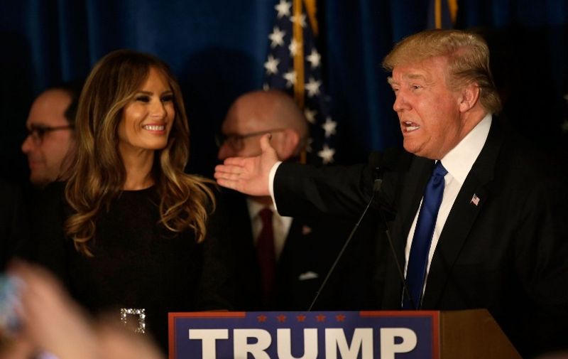 MANCHESTER, NH - FEBRUARY 09: Republican presidential candidate Donald Trump speaks as his wife Melania Trump looks on after Primary day at his election night watch party at the Executive Court Banquet facility on February 9, 2016 in Manchester, New Hampshire. Trump was projected the Republican winner shortly after the polls closed.   Matthew Cavanaugh/Getty Images/AFP
