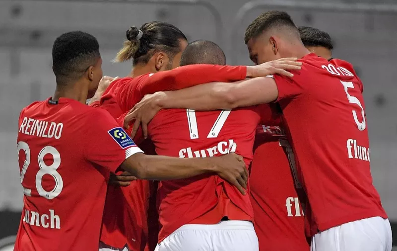 Lille's Canadian forward Jonathan David (C) is congratulated by teammates after scoring a goal during the French L1 football match between Angers SCO and Lille OSC at The Raymond-Kopa Stadium in Angers, north-western France on May 23, 2021. (Photo by LOIC VENANCE / AFP)