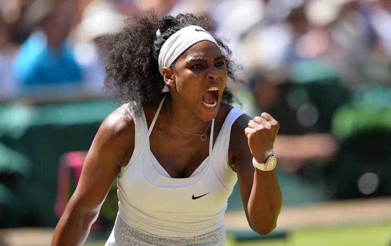 US player Serena Williams celebrates winning the first set against Spain's Garbine Muguruza during the women's singles final on day twelve of the 2015 Wimbledon Championships at The All England Tennis Club in Wimbledon, southwest London, on July 11, 2015.   RESTRICTED TO EDITORIAL USE  --  AFP PHOTO / GLYN KIRK