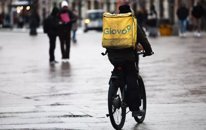 Glovo courier on a bike is seen in Warsaw, Poland on January 12, 2024. (Photo by Jakub Porzycki/NurPhoto) (Photo by Jakub Porzycki / NurPhoto / NurPhoto via AFP)