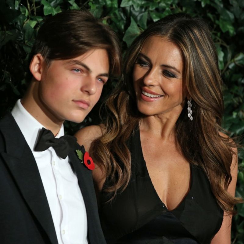British actress Elizabeth Hurley (R) and her son Damian pose on the red carpet as they attend the 62nd London Evening Standard Theatre Awards 2016 in London on November 13, 2016. - The Evening Standard Theatre Awards were established in 1955 to recognise outstanding achievement in London based Theatre, from actors to playwrights, designers to directors. (Photo by DANIEL LEAL-OLIVAS / AFP)