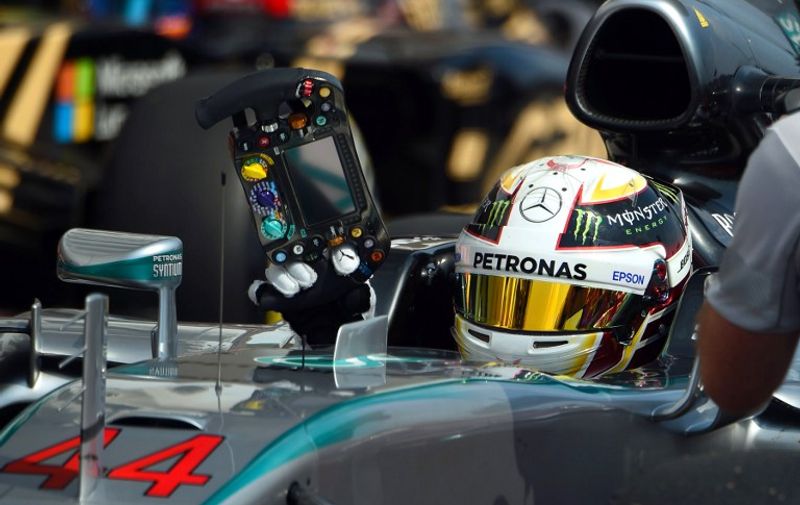 Mercedes AMG Petronas F1 Team's British driver Lewis Hamilton celebrates reaching the pole position after the qualifying session at the Hungaroring circuit  near Budapest on July 25, 2015, on the eve of the  Hungarian Formula One Grand Prix. 
AFP PHOTO / ATTILA KISBENEDEK