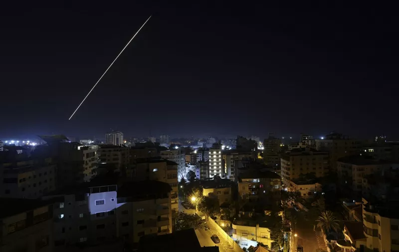 A long exposure shows a light trail from a projectile fired from Gaza City as Israel launched air strikes on the Palestinian enclave early on January 27, 2023. - Israel launched air strikes on Gaza on January 27 in response to militant rocket fire from the Palestinian enclave, as tensions rise following the deadliest army raid on the occupied West Bank in years. (Photo by MOHAMMED ABED / AFP)