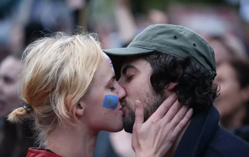 A couple kiss at an anti-Brexit protest in Trafalgar Square in central London on June 28, 2016.
EU leaders attempted to rescue the European project and Prime Minister David Cameron sought to calm fears over Britain's vote to leave the bloc as ratings agencies downgraded the country. Britain has been pitched into uncertainty by the June 23 referendum result, with Cameron announcing his resignation, the economy facing a string of shocks and Scotland making a fresh threat to break away. / AFP PHOTO / JUSTIN TALLIS