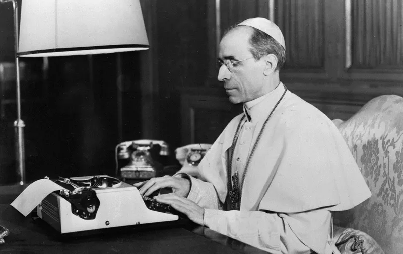 This undated photo provided by Italian news agency Ansa on February 23, 2020 shows Pope Pius XII using a typewriter at his study in the Vatican. - The entire Vatican archives on the pontificate of Pope Pius XII (1939-1958) are to open on March 2, 2020, a decision which had been called for decades by Jewish historians and organizations. (Photo by STRINGER / ANSA / AFP) / Italy OUT