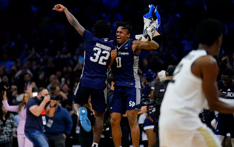 Saint Peter's Jaylen Murray, left, and Latrell Reid celebrate after Saint Peter's won a college basketball game against Purdue in the Sweet 16 round of the NCAA tournament, Friday, March 25, 2022, in Philadelphia. (AP Photo/Matt Rourke)