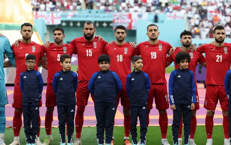 Iran players listen to the national anthem ahead of the Qatar 2022 World Cup Group B football match between England and Iran at the Khalifa International Stadium in Doha on November 21, 2022. (Photo by FADEL SENNA / AFP)