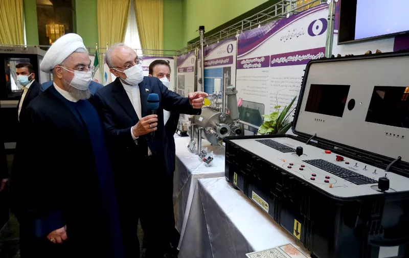 TEHRAN, IRAN - APRIL 10: (----EDITORIAL USE ONLY – MANDATORY CREDIT - "PRESIDENCY OF IRAN / HANDOUT" - NO MARKETING NO ADVERTISING CAMPAIGNS - DISTRIBUTED AS A SERVICE TO CLIENTS----) President of Iran, Hassan Rouhani (L) and head of the Atomic Energy Organization of Iran Ali Akbar Salehi (2nd L) visit Nuclear Technology exhibition on the 11th anniversary of National Nuclear Technology Day in Tehran, Iran on April 10, 2021. Iranian Presidency/Handout / Anadolu Agency (Photo by Iranian Presidency/Handout / ANADOLU AGENCY / Anadolu Agency via AFP)